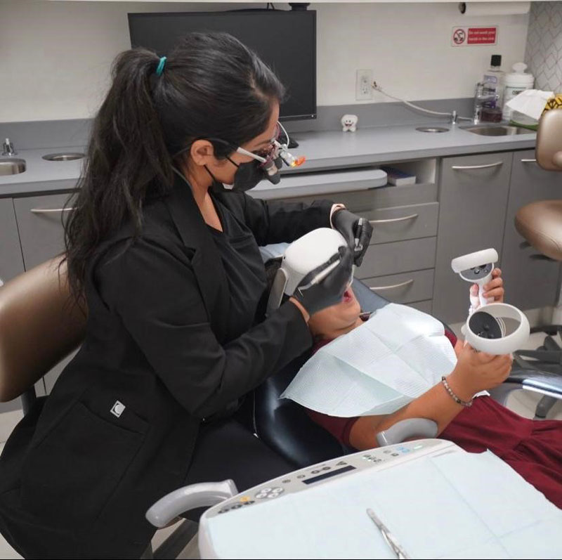 Dentist performing a thorough oral cancer screening with modern diagnostic technology